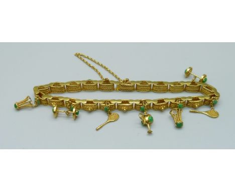 A yellow metal and jade set bracelet with badminton related charms, marked 14k, 16.5g 