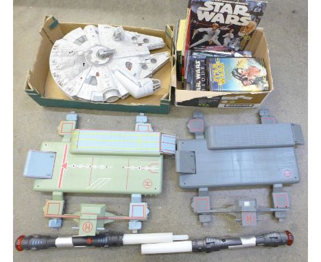 A Star Wars Millennium Falcon model, two light sabers, two landing ports and a collection of Star Wars books, etc. **PLEASE N