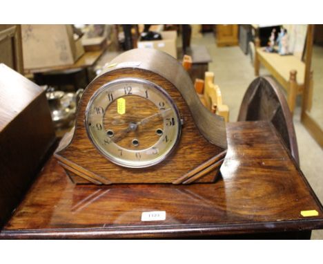 An oak cased three hole mantel clock 