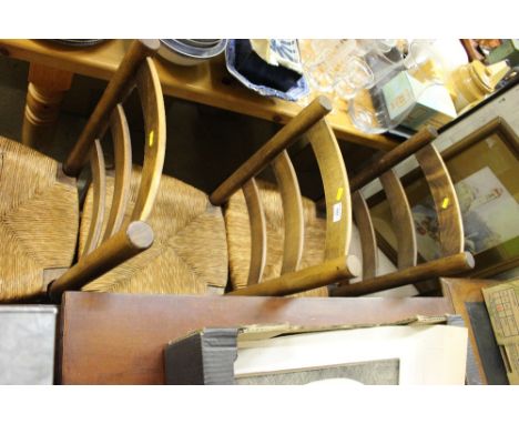 A set of four ladder back and rush seated kitchen chairs