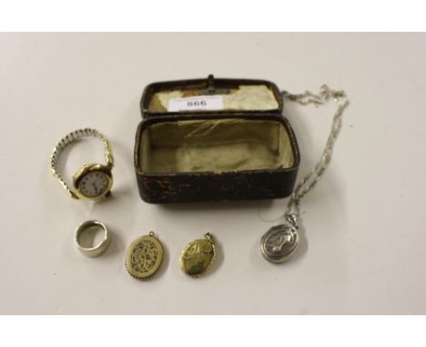 Two yellow metal lockets; a white metal similar with horses head decoration; a ladies yellow metal wrist watch; and a white m