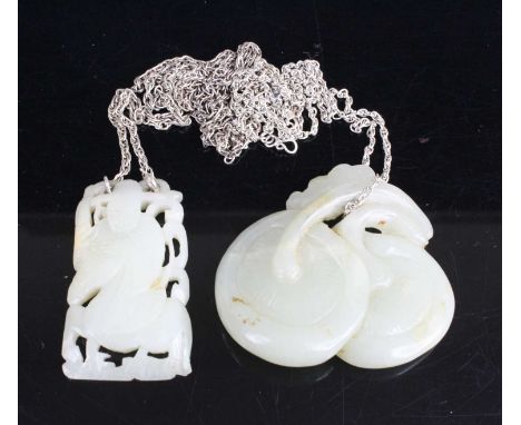 A Chinese carved celadon jade pendant depicting a robed figure on horseback, 5cm; together with one other of fruit, 6 x 5cm, 