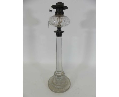 A Victorian cut clear glass oil lamp, having a thumb cut font and faceted stem, lacking shade, height 70cmA few minor chips b