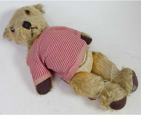 A vintage blond mohair teddy-bear, having stitched body, glass eyes and moveable limbs, h.40cm 