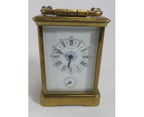 A lacquered brass carriage clock having a white enamel dial with Roman numeral markers and Arabic outer markers, signed Wilso