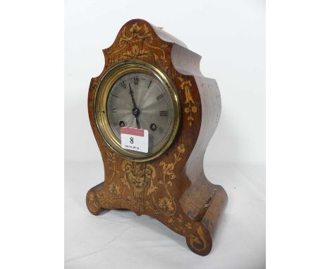 An early 20th century mahogany mantel clock, the silvered dial showing Roman numerals, the 8-day movement striking on a bell,