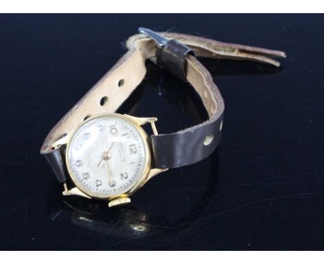 A lady's vintage Westwind 18ct gold cased manual wind wristwatch, having signed Arabic dial, dia.22mm, on leather bracelet 
