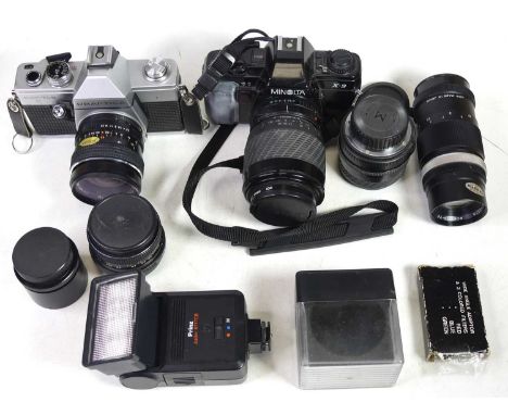 A collection of cameras and lenses, to include a Minolta Rokkor-TC 135mm lens, and a Pentacon Auto 1.8/50 multicoating lens 