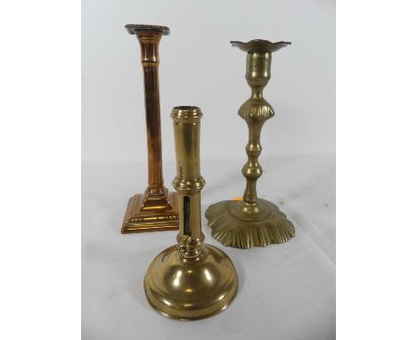 An 18th century brass table candlestick, height 24.5cm, together with two others (3)