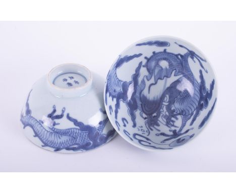 A pair of Chinese blue and white porcelain tea bowls decorated with dragon chasing flaming pearl, with four character mark, h