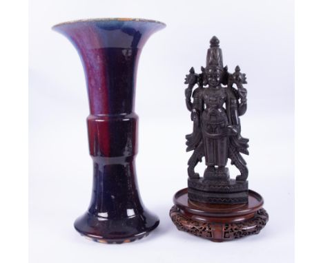 A large ceramic vase of Japanese style, height 44cm with wooden stand together with a carved wooden deity figure (2).