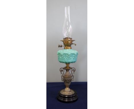 A Victorian oil lamp with turquoise reservoir with brass and ceramic base, height excluding chimney 47cm.