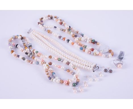 A mixed selection of pearl jewellery to include two long strands of multi-coloured pearl necklaces, a three strand freshwater