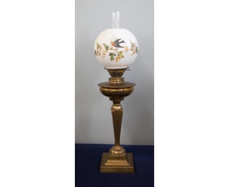 A Victorian oil lamp with white shade decorated with flowers, height excluding chimney 63cm.