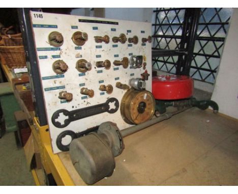 A collection of vintage sprinkler heads (for putting out fires), an automatic sprinkler gauge and two spanners, mounted on a 