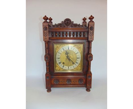 German oak cased mantle clock, the architectural case with turned spindles and carved flower head roundel's fitted with a 16c