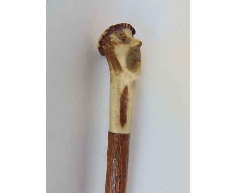 Horn knopped walking stick carved with the head of Tam Shanter