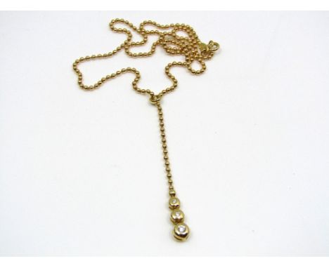 A diamond necklace set with three graduating stones, largest 0.05cts approx, on bead chain marked 750, 8g (with 2016 insuranc