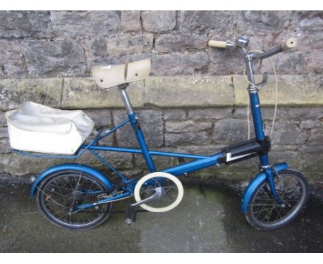 A vintage Moulton bicycle with metallic blue coloured frame and Sturmey Archer three speed