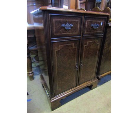 A good quality reproduction side cabinet in the Georgian style, figured walnut veneered and enclosed by a pair of doors with 