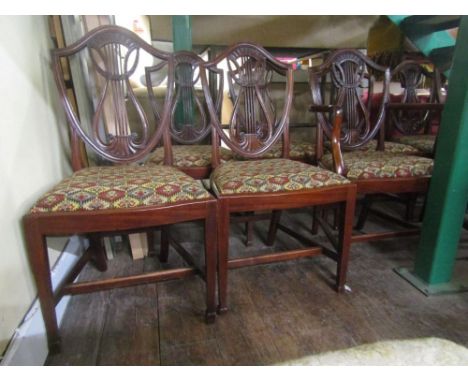 A set of eight Hepplewhite shield back dining chairs (6+2) the shield shaped back with lyre shaped splats and further laurel 