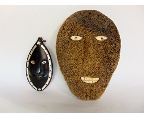 Tribal interest - Two interesting mask, one fossilized whale bone mask of Inuit origin, 26cm long; together with a further So