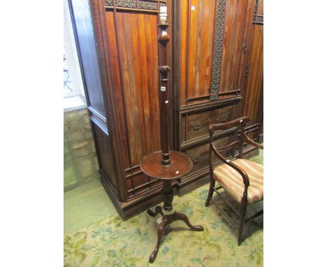 An Edwardian mahogany standard lamp with turned column central circular tray and shaped tripod 