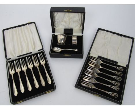 Two cased set of six silver dessert forks, one set with fancy pierced handles, 9oz approx; together with a further cased set 