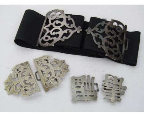 A late 19th century silver buckle pierced with scrolled acanthus, maker Deakin & Francis upon a black belt strap; together wi