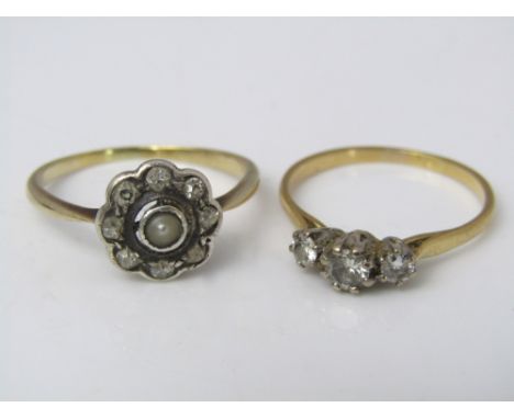 A three stone diamond ring together with a further daisy head ring set with diamonds and a central pearl, both unmarked, size