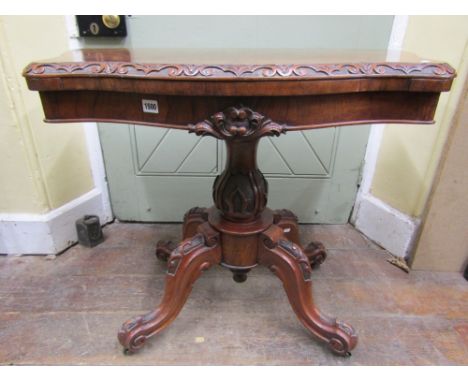 A Victorian walnut and burr-walnut fold over top card table with serpentine front raised on a carved vase shaped pillar platf