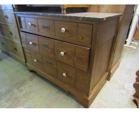 A 19th century pitch pine commode of three long graduated drawers beneath a decorative veined marble top