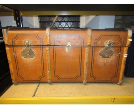 A vintage fibre and lathe bound cabin trunk with side stitched leather carrying handles and contents to include a selection o