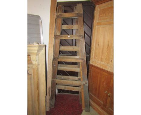 A pair of vintage pine A framed folding trestles, each bearing a rectangular brass label "The Eureka Sole Maker John Gregory 