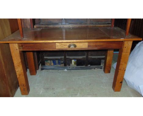 A vintage oak kitchen table, the rectangular top over a central frieze drawer raised on four square cut supports, the top 148