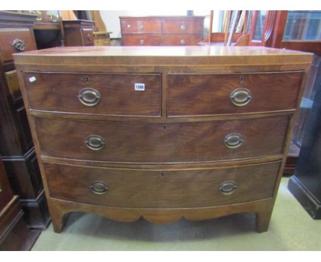 A Georgian mahogany bow fronted and caddy top bedroom chest of two long and two short drawers over a shaped apron and bracket