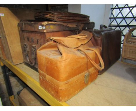 A vintage tan leather coloured military related trunk with brass fittings, together with a Gladstone type bag and two others