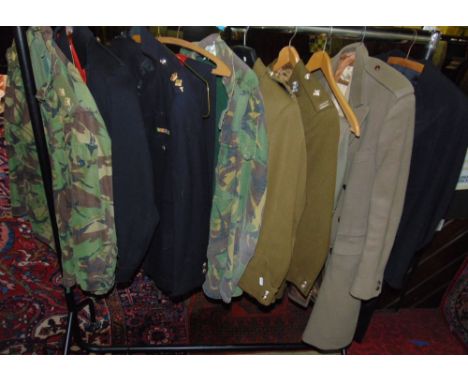 Collection of military garments including Nato army clothing and dress uniforms together with a tailcoat and woollen coat