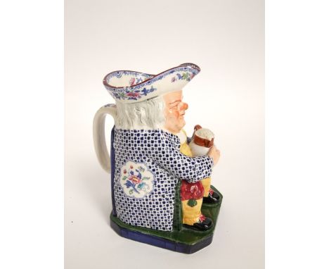 A Copeland Spode Toby jug in the 18th century manner, with blue and white printed floral coat and painted red breeches and ye