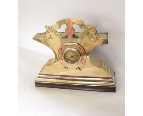 Heavy copper and brass novelty mantle clock of equine interest, with horse head pediment and horseshoe type bezel. around a w