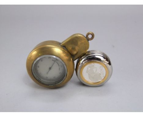 A pocket barometer held within a brass protective case and a contemporary desk watch/paperweight - Monnaire of Paris, commemo