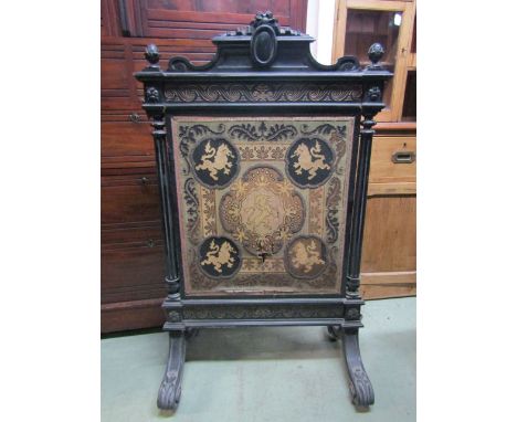 A 19th century fire screen, the ebonised frame with fluted columns, moulded pediment, scrolled gilt highlighted frieze enclos