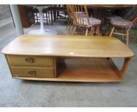 An interesting Ercol coffee table fitted with two drawers and big open recess upon castors, 120cm long