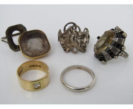 An 18ct ring set with a single diamond (af), size K 5.5g, together with three further rings (two silver) and a carved crystal
