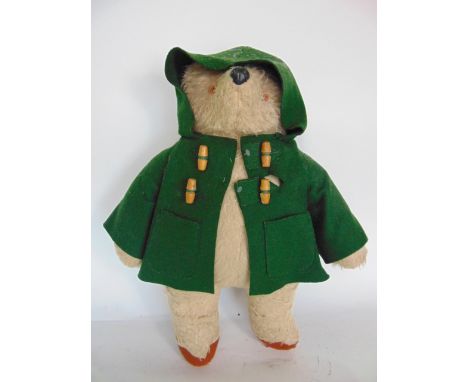 Old stuffed Paddington Bear with green duffel coat