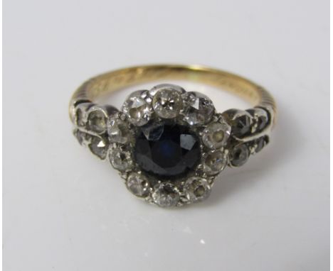 An early Victorian sapphire and diamond flower head cluster ring, the yellow metal band of twisted design, with inscription '