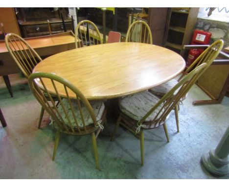 Ercol light elm oval dining table together with a set of six Windsor chairs (7)