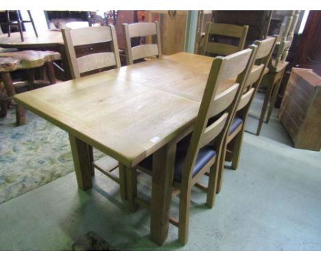 A good quality contemporary light oak extending dining table of rectangular form with single additional leaf and cleated ends