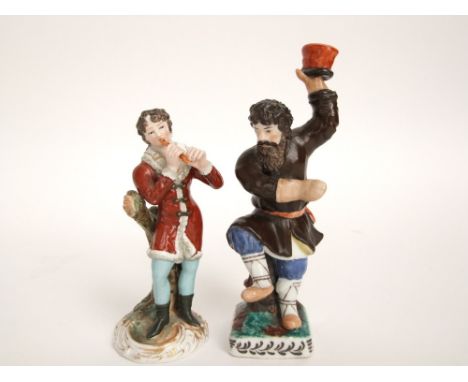 A 19th century ceramic figure of a boy piper in a red fur trimmed jacket playing the flute, raised on a circular scrolling ba
