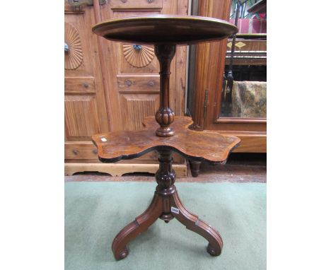 A Victorian walnut and burr-walnut two tier occasional table raised on three scrolled supports, the lower revolving shelf cro